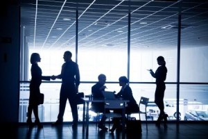 Silhouettes of people in a conference room.