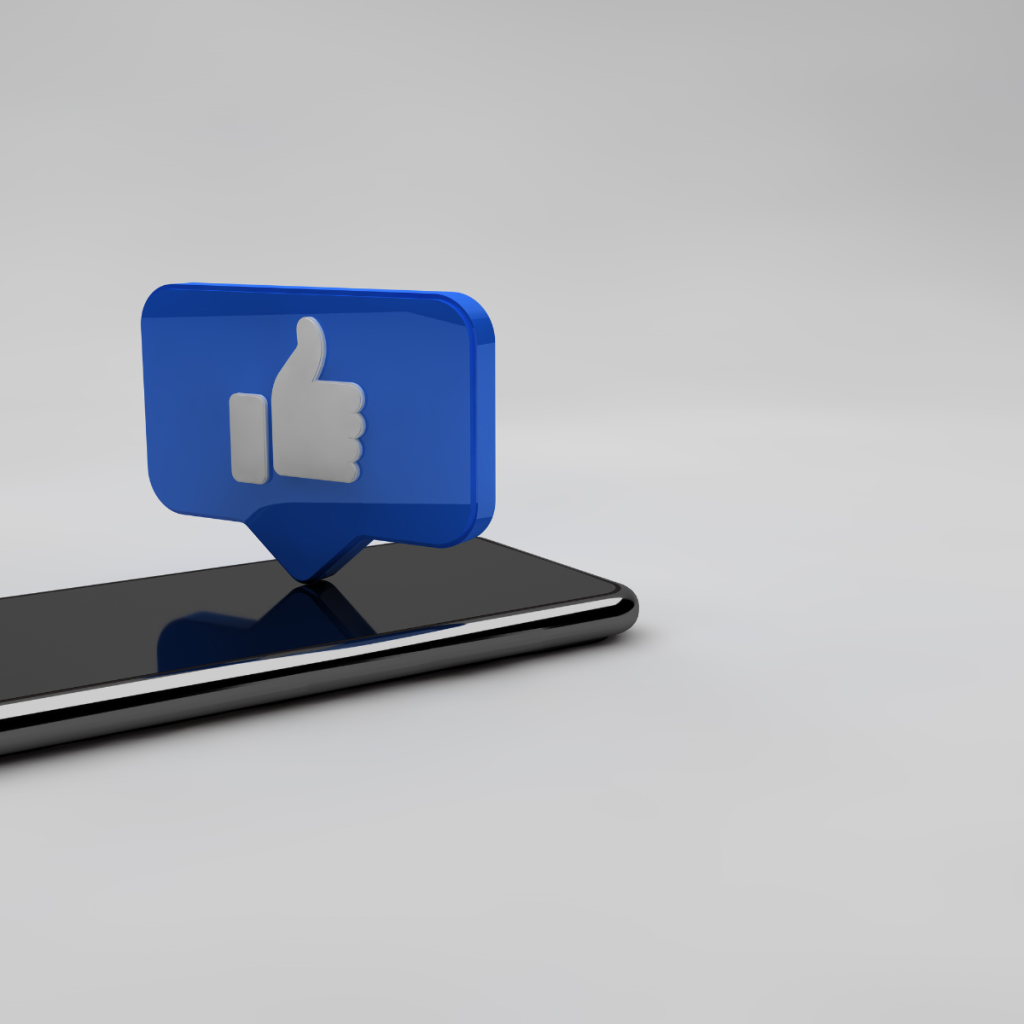 Pins with Facebook logos on them scattered on white surface.