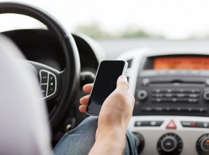 Person looking at their phone while in car.