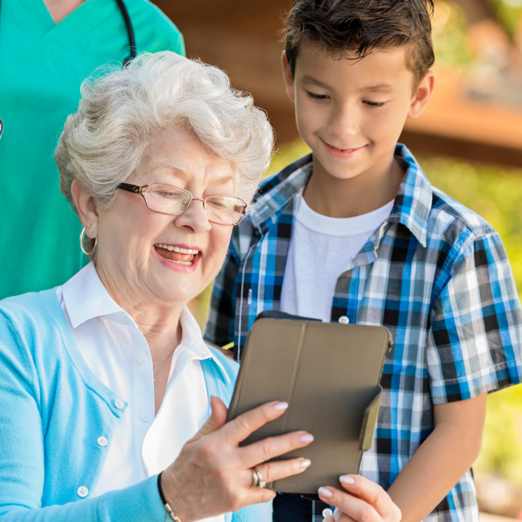 Grandson showing grandma something on the laptop.