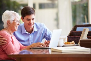 Grandson showing grandma something on the laptop.