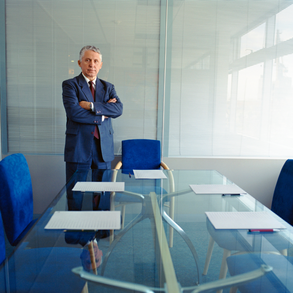 Business man standing in a conference room.