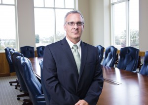 Business man standing in a conference room.