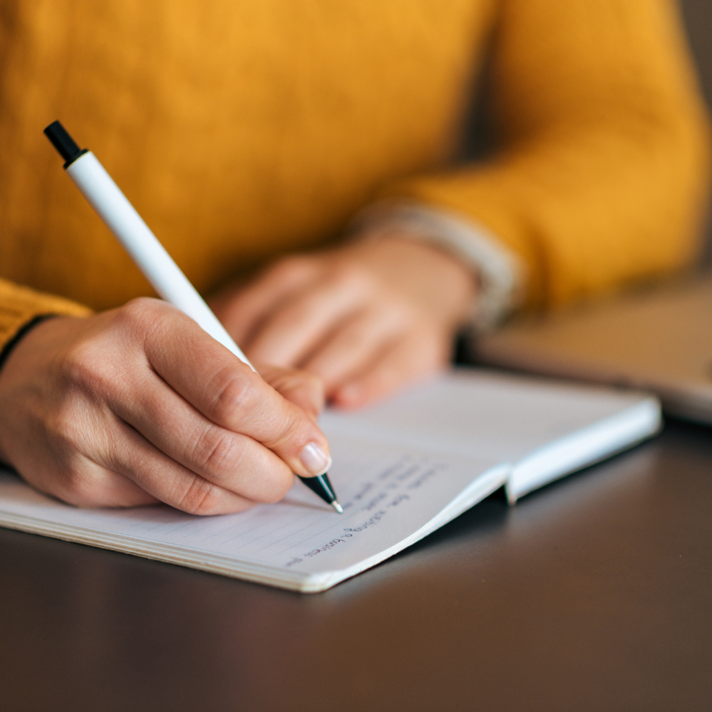 Man writing in a notebook.