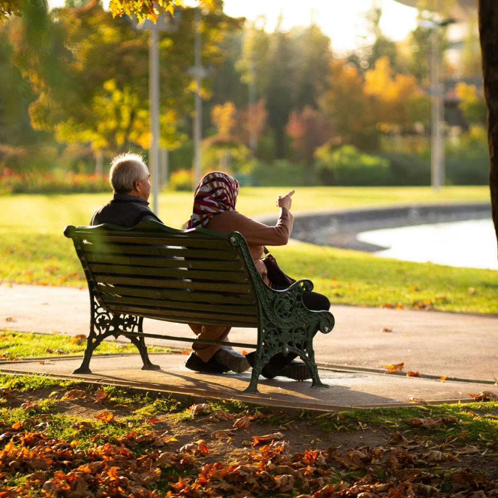 Older couple sitting outside, enjoying the view.