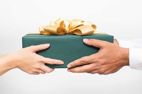 Handing over a gift box with a yellow bow.