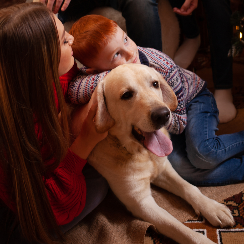 A golden retriever surrounded by a family.