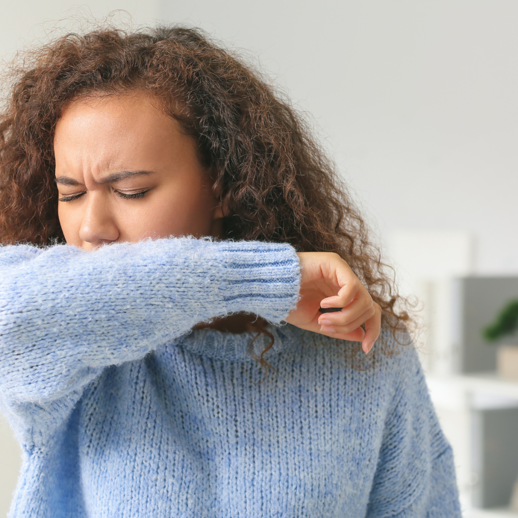 Sick woman at home, coughing.