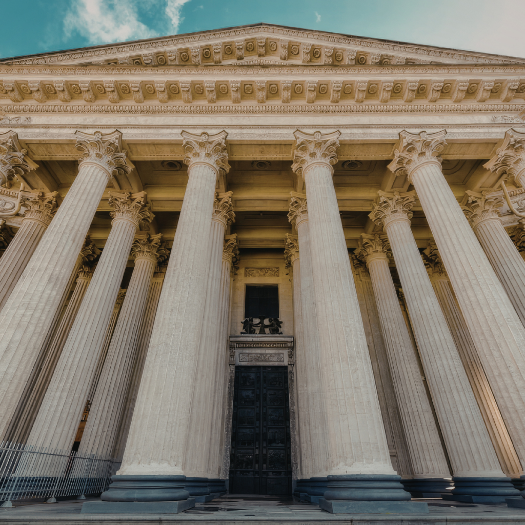 Government building in classical style with columns.