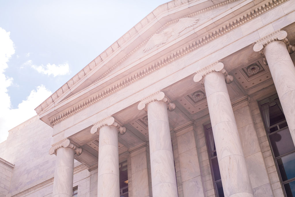 Government building in classical style with columns.