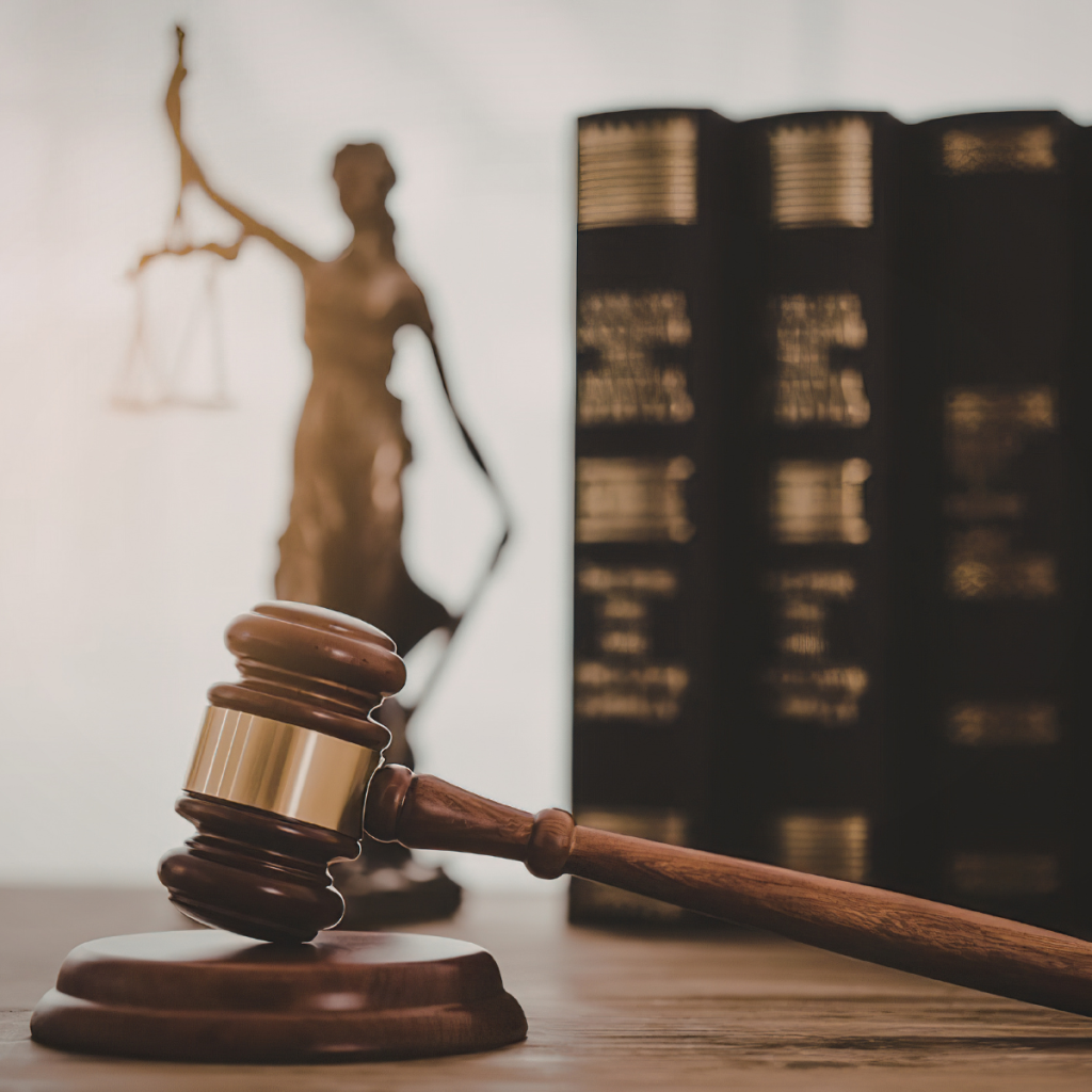 Discrimination Laws sign on top of a desk beside gavel.