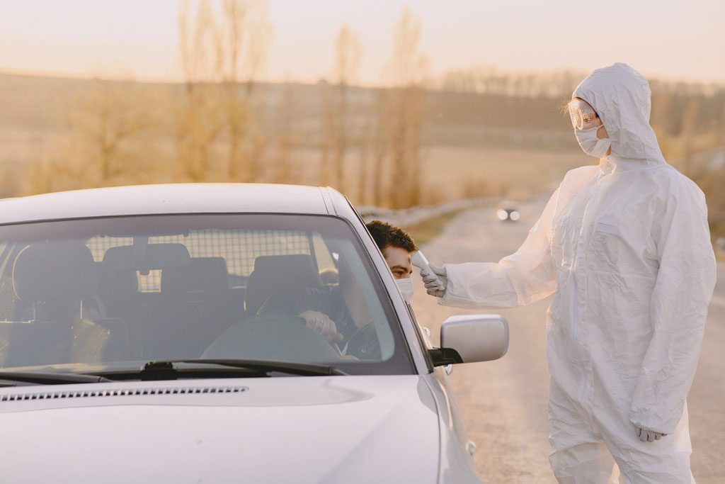 Checking the temperature of a person in a vehicle.